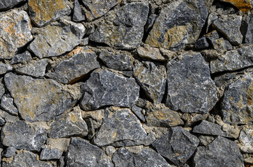 Sunlit stone masonry wall background