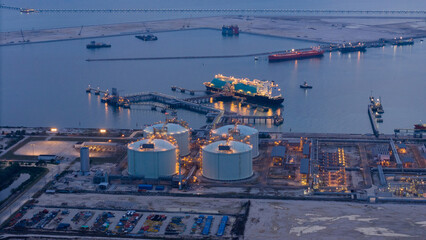 LNG (Liquified Natural Gas) tanker anchored in Gas terminal gas tanks for storage. Oil Crude Gas Tanker Ship. LPG at Tanker Bay Petroleum Chemical or Methane freighter export import transportation