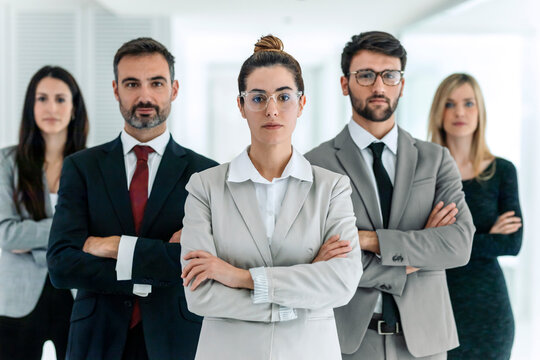 Confident business team standing together in corporate office