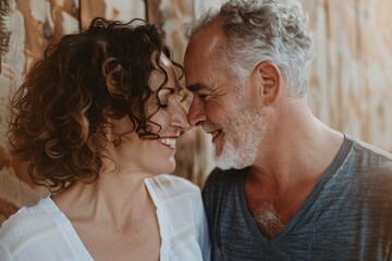 Portrait of a smiling couple in their 40s standing face to face having intimate romantic moment