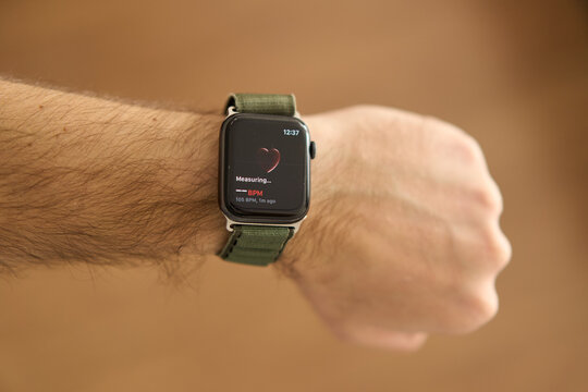 A square smartwatch on a man's hand close up. Heart rate measurement on watch. High quality photo