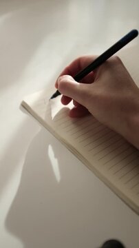 Hand writing journaling. Beautiful light slow motion video. Gratitude journal, mental self care, mindfulness, self reflection, creatine writing. Concept of education, self planning, to do list.