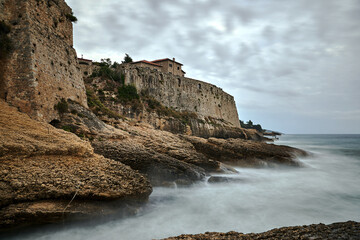 Rocks and stone walls of a medieval castle on the seashore in Ulcinj