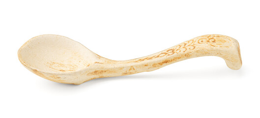 Rustic handmade ceramic spoon with vintage decorative pattern isolated on white background.