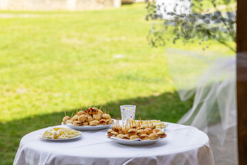 Appetizers and mini sandwiches on table for outdoor buffet event