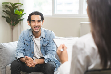 Psychology, depression. Happy smile asian young man patient mental therapy explain symptom with...