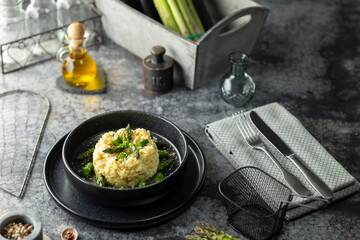Asparagus risotto dish plating with olive oil and spices