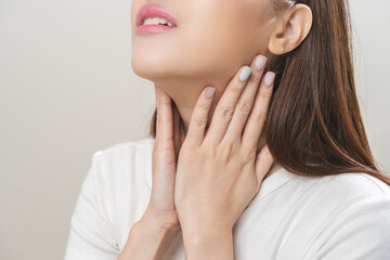 Sickness in inflaming asian young woman, girl use hand check self touch at sore throat, pain...