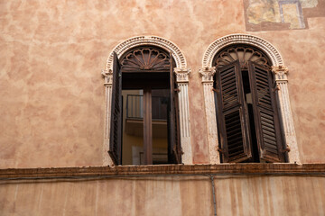 Gothic-style windows of the Casa di Giulietta Juliet House in Verona, Italy, showcasing medieval architecture, ornate stonework, and the historic charm of the legendary Shakespearean landmark