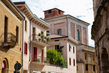 Obraz premium Streets of Verona, Italy - charming medieval lanes lined with colorful buildings, cobblestone paths, historic architecture, bustling cafes, and vibrant city life in the Veneto region