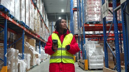 Female warehouse worker scanning barcodes in cold storage facility - Powered by Adobe