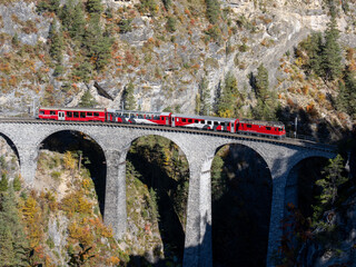 Train crosses the Landwasser viaduct near Filisur Switzerland