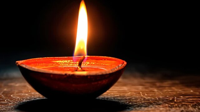 Beautiful Diya with Flickering Flame for Ananta Chaturdashi Celebration