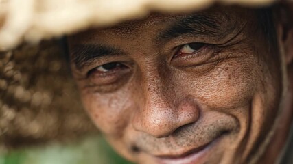 Portrait of Wisdom: A close-up shot of an elderly individual, his eyes sparkling with a lifetime of experience and wisdom. A Straw hat adds a touch of mystery.