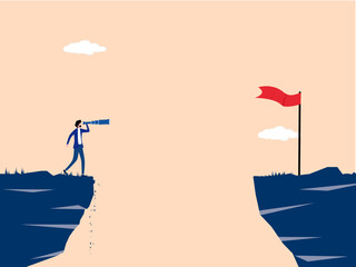 businessman looks across a gap in the cliff with a telescope at the new flagpole