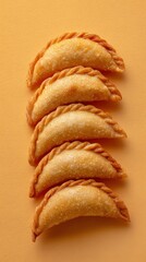 Crescent-shaped Lebanese Sambousek with golden crust, dish from Lebanon on yellow background, minimalist food photo, template for social media, digital ads, web banner, mobile wallpaper, greeting card