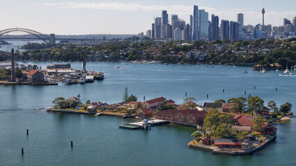 Naklejka premium Aerial drone view of Spectacle Island on Parramatta River and Sydney Harbour, in Sydney, NSW Australia in October 2025 with Sydney City in the background 