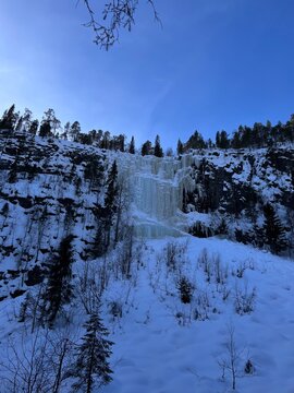 Breathtaking winter landscape with frozen waterfalls under a blue sky in the Korouoma Gorge in Finnish Lapland