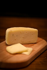 Craft cheese cut into pieces on a cutting board