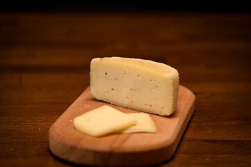 Craft cheese cut into pieces on a cutting board