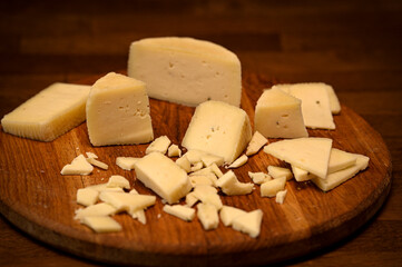 Craft cheese cut into pieces on a cutting board