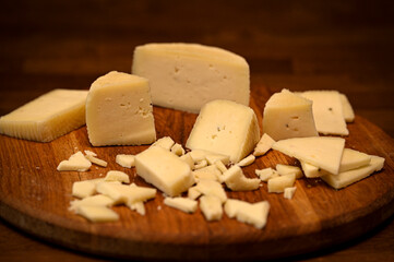 Craft cheese cut into pieces on a cutting board