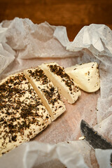 Craft cheese cut into pieces on a cutting board