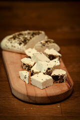 Craft cheese cut into pieces on a cutting board