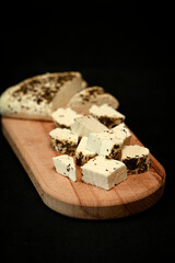 Craft cheese cut into pieces on a cutting board