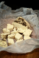 Craft cheese cut into pieces on a cutting board