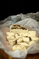 Craft cheese cut into pieces on a cutting board
