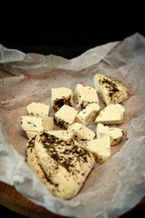 Craft cheese cut into pieces on a cutting board