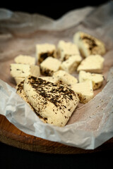 Craft cheese cut into pieces on a cutting board