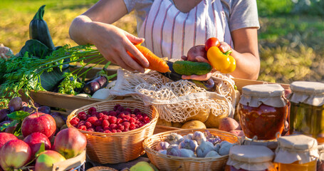 A woman farmer sells fruits and vegetables at a farmers market. Selective focus.