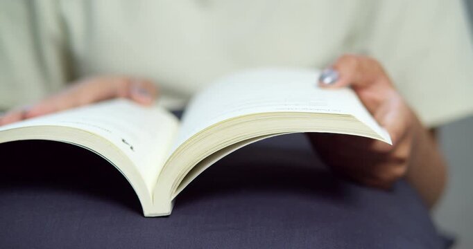 A person immersed in a book showcasing joy of reading in a cozy home setting.