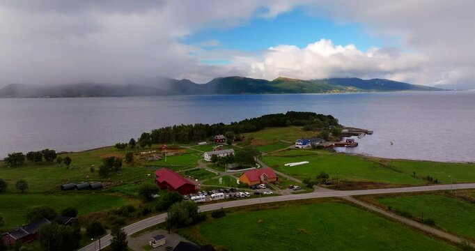 Scenic setting of Kvitnes G&aring;rd farmstead on fjord in Vester&aring;len, Norway. Aerial