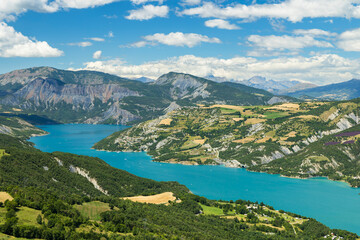 Serre Poncon lake between mountains and green landscape in France
