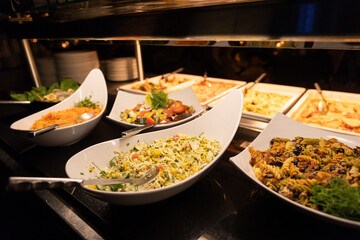 Buffet full of hot and cold dishes in the hotel restaurant during dinner for guests