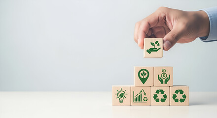 Hand adding wooden block with plant icon to eco-friendly symbols