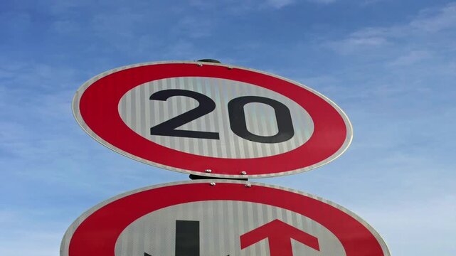 Zooming in on a 20 mph or 20 kph speed sign 	