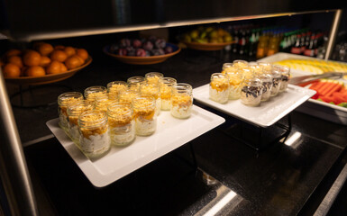 Delicious desserts in jars served at the buffet to guests in the restaurant