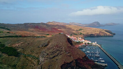 Panorama coastal town lying stony shore with red roof houses. Beautiful marina