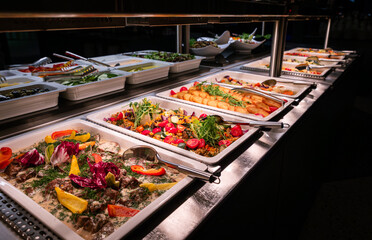 Buffet full of hot and cold dishes in the hotel restaurant during dinner for guests