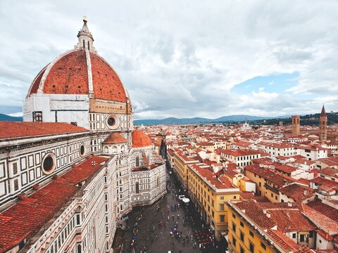 Aerial view of Florence, Italy. Dome of the Duomo (Florence Cathedral) and a cityscape of terracotta rooftops - Powered by Adobe