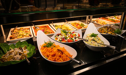 Buffet full of hot and cold dishes in the hotel restaurant during dinner for guests