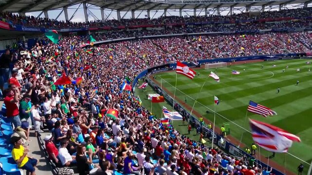 Huge crowd of spectators waving flags in stadium