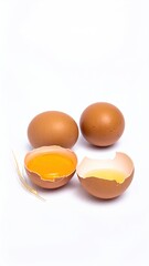 Three brown eggs, one cracked open, revealing yolk and white