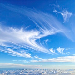 Whimsical clouds dance across a vibrant blue sky, with a layer of low clouds below