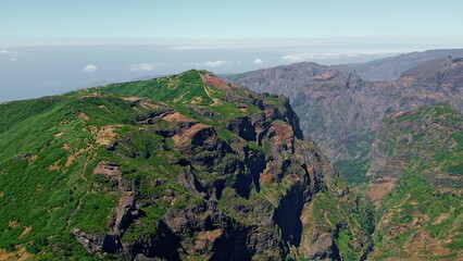 Rocky cliffs steep mountain covered with vegetation. Aerial landscape Madeira