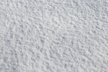 Detailed surface texture of fresh sparkling snow illuminated by the bright winter sun Natural white background and texture perfect for winter design festive mood or copy space